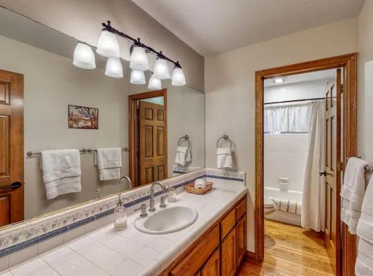 Large bathroom with separate tub just outside 4th bedroom with bunk beds.